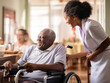 © Moritz - Compassionate Bonds: Side View Portrait of a Young Black Woman Assisting a Senior Man in a Nursing Home