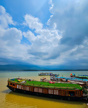 Houseboats Stationed At The Bank Of The Jadukata River In Sunamganj, Bangladesh Near The India Bangladesh Border With Clouds In The Sky During The Rainy Season.