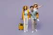 © ViDi Studio - Traveler parents mom dad with child girl wear casual clothes hold bags, sit on back isolated on plain purple background Tourist travel abroad in free time rest getaway Air flight trip journey concept