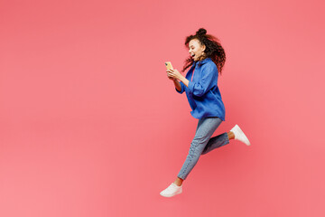 full body side view young woman of african american ethnicity wear blue shirt casual clothes jump hi