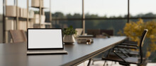 Close-up Image Of A Laptop Mockup On A Modern Meeting Table In A Contemporary Meeting Room.