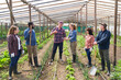 © Robert Kneschke - Multiracial farmers discussing over tablet PC at greenhouse