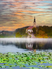 Sticker - Lake Bled Slovenia. Beautiful mountain lake with small Pilgrimage Church. Most famous Slovenian lake and island Bled with Pilgrimage Church of the Assumption of Maria and Bled Castle in background.