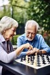shot of a senior man playing chess with his wife outside