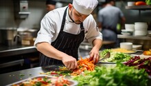 Chef Preparing Vegetable Salad In The Kitchen Of A Restaurant Or Hotel