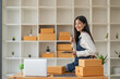 © Natee Meepian - Startup SME small business entrepreneur of freelance Asian woman using laptop and box to receive orders online to prepare to pack sell to customers, online sme business ideas