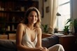 © ProstoSvet - Woman in a white tank top sitting on a brown couch in a home