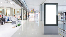 Blank Billboard In A Modern Shopping Center. Display For Mock-up And Advertising. Blackground With Mannequins In Fashion Shop Display Window.