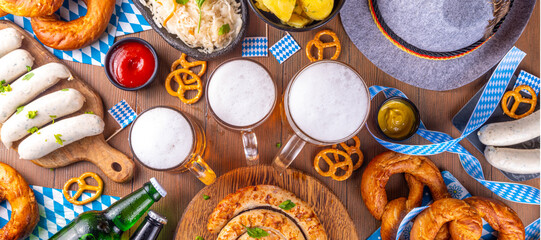  Oktoberfest munich traditional festival menu foods - bavarian sausages, pretzels, potato, sauerkraut, beer bottle and mug,  Background flyer for Oktoberfest invitation on old wooden table