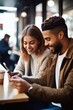 © OMD - shot of a young couple using their smartphones while having coffee in a cafe