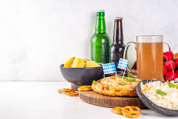 Wall Mural -  Oktoberfest munich traditional festival menu foods - bavarian sausages, pretzels, potato, sauerkraut, beer bottle and mug,  Background flyer for Oktoberfest invitation on old wooden table