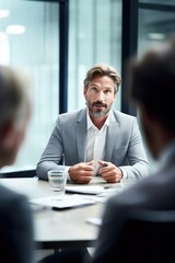 Wall Mural - shot of a confident businessman having a meeting with colleagues in an office