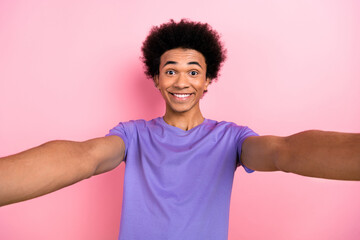 Wall Mural - Photo of toothy beaming nice guy with perming coiffure wear stylish t-shirt making selfie smiling isolated on pink color background