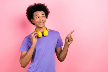 Photo of funky nice man wear purple stylish clothes looking up empty space cool offer proposition isolated on pink color background