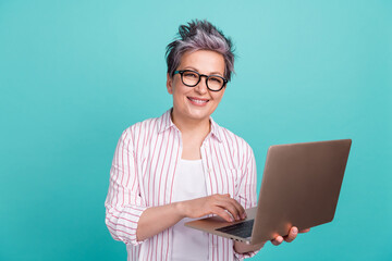 Wall Mural - Portrait photo of young model hr department employee woman using laptop find new applicants for job isolated on aquamarine color background