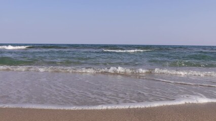 Wall Mural - white waves in the blue sea on the beach