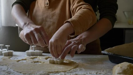 Wall Mural - Mother and son making gingerbread cookies at kitchen at home, Poland