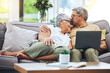 © Joshua A/peopleimages.com - Laptop, love and senior couple on sofa for watching movies, entertainment or streaming in living room. Retirement, marriage and happy man and woman kiss on computer for bonding, relax or film at home