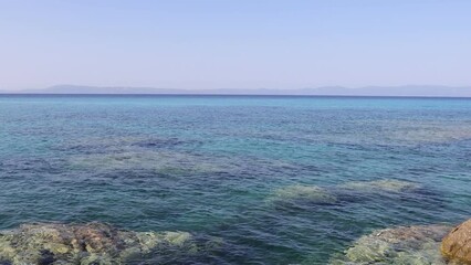 Wall Mural - a blue transparent sea in the mountains