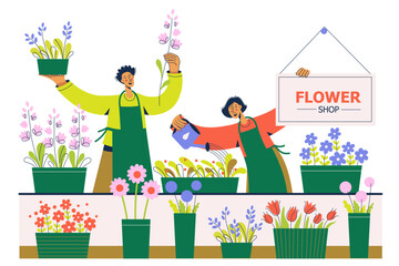 People work at florist shop or store. Woman and man sells flowers. Flower shop with flowers and plants in pots.