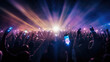 © Sasint - A crowd of people at a live event, concert or party holding hands and smartphones up