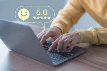 Male customer using a computer laptop in give rating to service experience assessment on application. Online customer review satisfaction feedback survey and testimonial.
