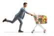 © Ljupco Smokovski - Full length profile shot of a male teenager running with a full shopping cart