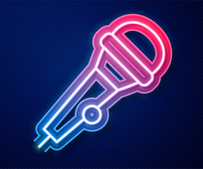 Poster - Glowing neon line Microphone icon isolated on blue background. On air radio mic microphone. Speaker sign. Vector