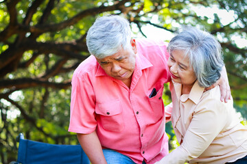 Wall Mural - Sick elderly man in a wheelchair His wife helped support himself. Life and health insurance for retired seniors