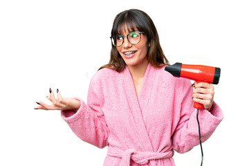 Wall Mural - Young caucasian man holding a hairdryer over isolated chroma key background with surprise facial expression