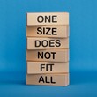 One size does not fit all symbol. Concept words One size does not fit all on wooden blocks.One size does not fit all business concept. Copy space.3D rendering on blue background.
