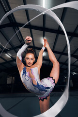 Sticker - Woman, portrait and balance for ribbon gymnastics in competition, performance or concert in dark arena. Flexible dancer, rhythm and agile athlete training with talent, creative contest or sports show