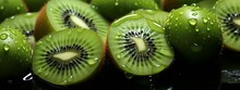 A Detailed Exploration Of A Kiwi Slice, Revealing Its Intricate Green Patterns And Minuscule Seeds, Encapsulating Nature's Artistry.