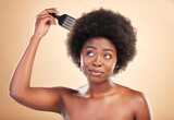 Afro, hair care and black woman in studio with comb for wellness, beauty and salon hairstyle. Haircare, treatment and happy African girl with curls, tools and beige background for luxury spa routine.