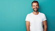 © Studio Nova - Man standing in front of camera in white T-shirt , isolated on blue background