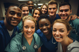 Fototapeta Sport - Medical doctors and nurses take a selfie in the corridor of the hospital at the end of a hard day's work