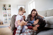 © Geber86 - Young caucasian family having fun and playing together in the living room
