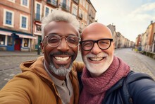 Interracial Senior Couple Of Gay Travellers Taking Selfie In City, Men On Autumn Europe Vacation