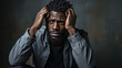 © AS Photo Family - Depressed african american man sitting on a dark grunge background.