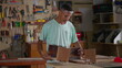 © Marco - One Young Black Apprentice working at Carpentry Workshop. Craftmanship job occupation building furniture