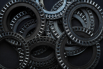 Lot of metal bearings on a dark background. Machinery concept, spare part of oil production equipment.