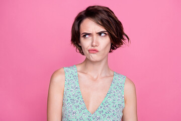 Portrait of young girl brown hair pouted lips wearing trendy print flowers top grimace look empty space isolated on pink color background