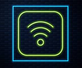 Sticker - Glowing neon line Wi-Fi wireless internet network symbol icon isolated on brick wall background. Vector