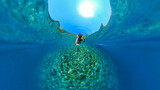 Fototapeta  - Man snorkeling with 360 degree underwater camera in the beautiful, crystal clear sea at Zuljana beach, Croatia