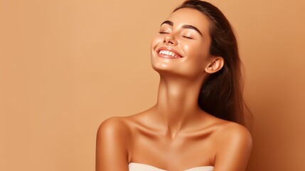 Portrait of smiling girl enjoying beauty treatment on beige background. Beautiful natural woman looking at copy space, spa and wellness concept. Carefree laughing woman with bare shoulders isolated.