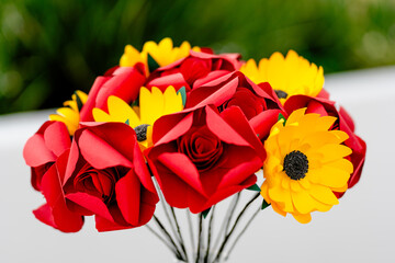 vase of handmade flowers on a table in the garden - side view 2