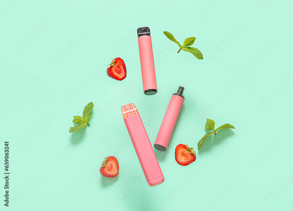 Electronic cigarettes with strawberry and mint on turquoise background