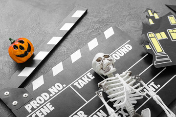 Sticker - Clapperboard with different Halloween decor on grunge blue background