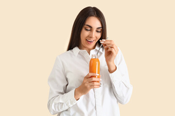 Poster - Young woman with bottle of juice on light background