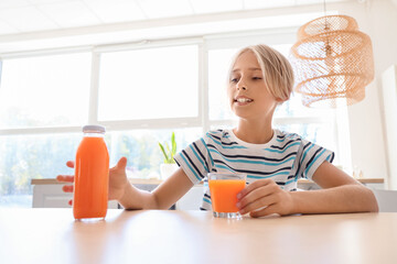 Sticker - Little boy with glass and bottle of juice in kitchen